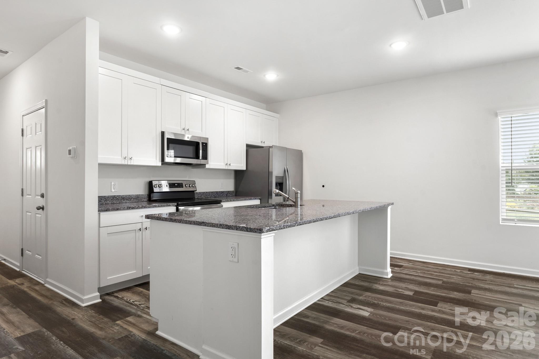 112 Angle Street Cherryville, NC 28021 - Photo 34 of 46 a kitchen with stainless steel appliances a sink stove refrigerator and a window