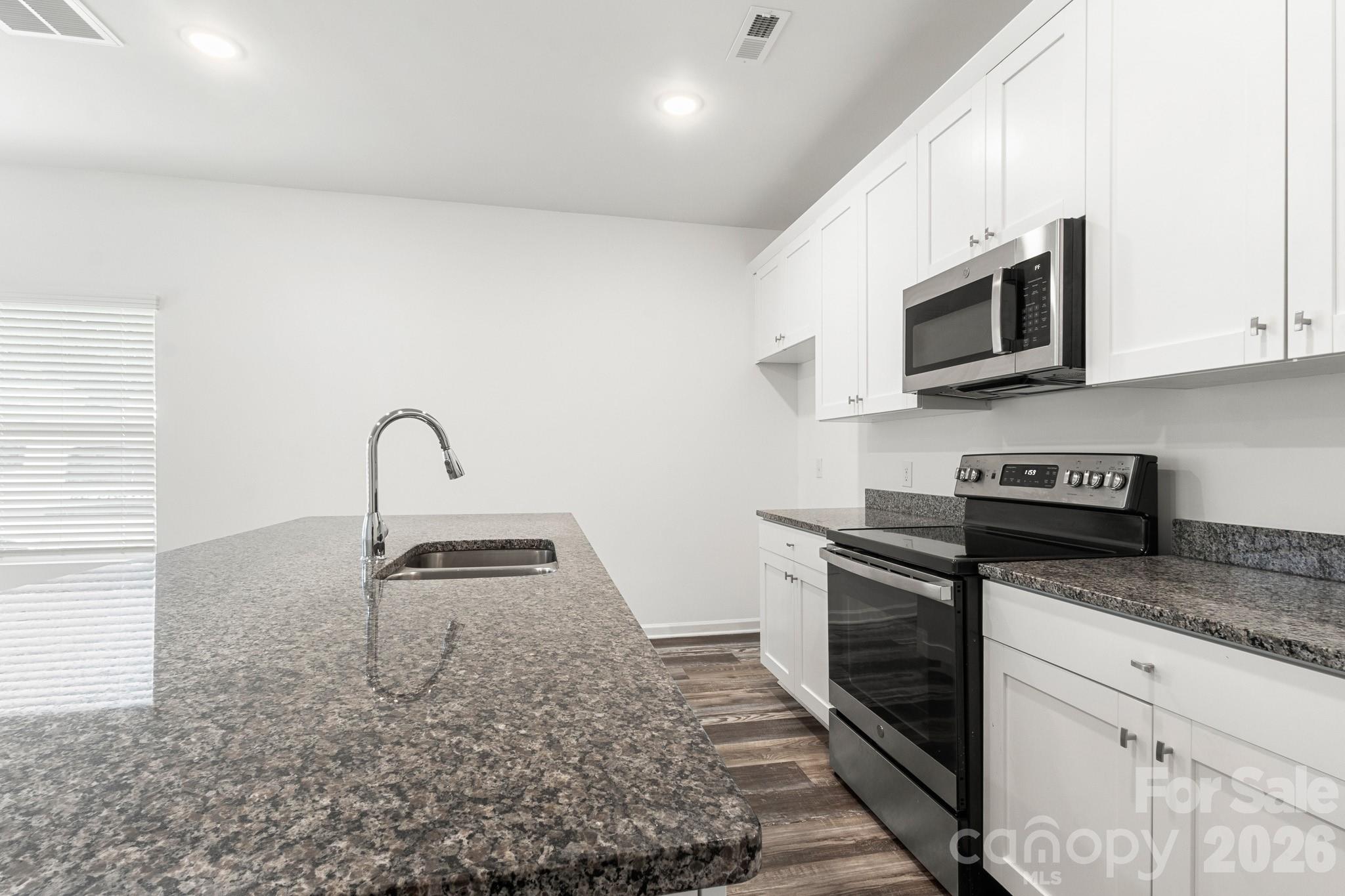 112 Angle Street Cherryville, NC 28021 - Photo 7 of 46 a kitchen with granite countertop a stove and a sink