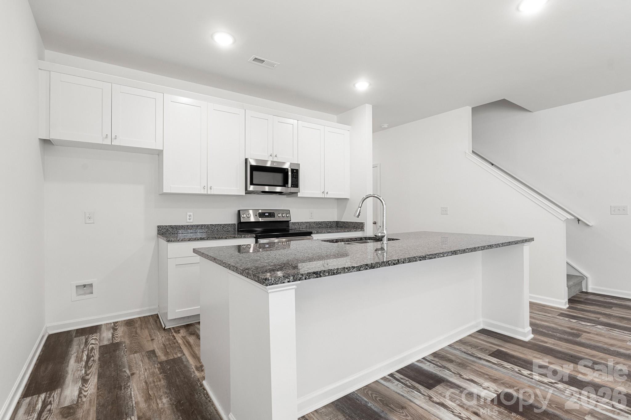 112 Angle Street Cherryville, NC 28021 - Photo 9 of 46 a kitchen with stainless steel appliances granite countertop a sink and a stove