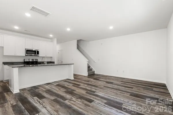 a kitchen with stainless steel appliances a refrigerator and microwave