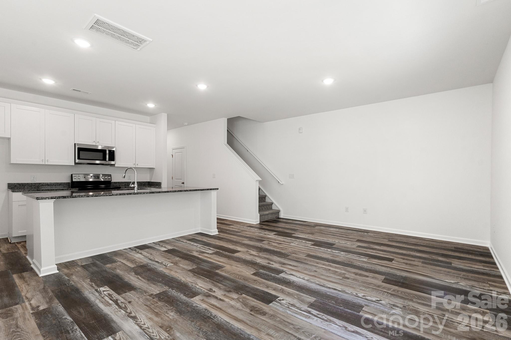 112 Angle Street Cherryville, NC 28021 - Photo 10 of 46 a kitchen with stainless steel appliances a refrigerator and microwave