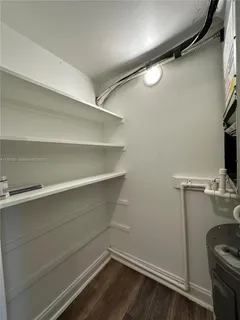 a view of storage and utility room with racks on the wall