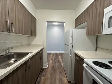 a kitchen with a sink and a refrigerator