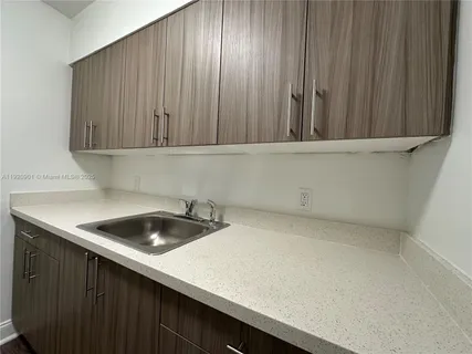 a kitchen with a sink and cabinets