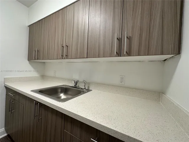 a kitchen with a sink and cabinets