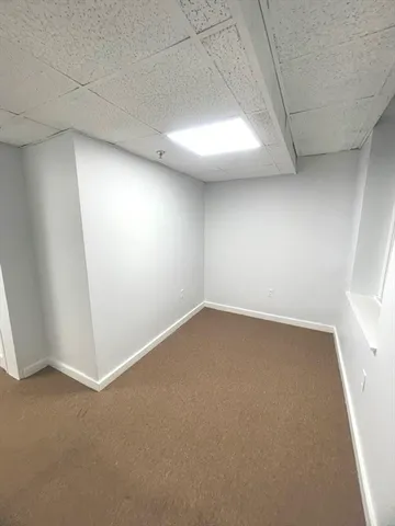an empty room with a empty space and windows