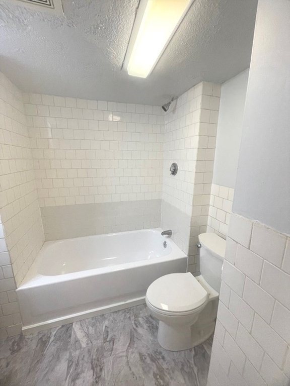 475 Commonwealth Avenue, Unit G3 Boston, MA 02215 - Photo 14 of 20 a bathroom with a bathtub and a toilet