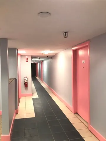 a hallway with windows and painted walls