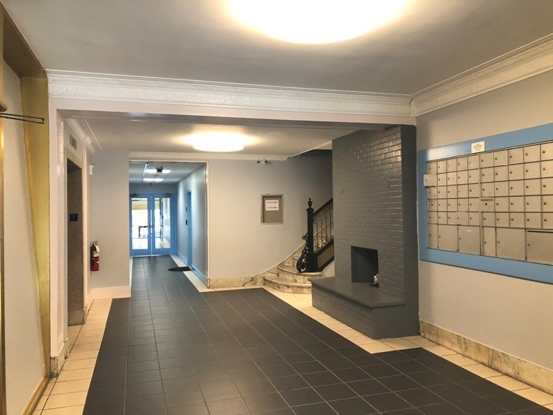 475 Commonwealth Avenue, Unit G3 Boston, MA 02215 - Photo 19 of 20 a view of a hallway with wooden floor and a fireplace