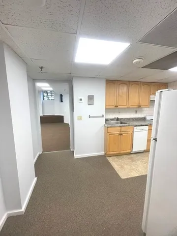 a view of kitchen with refrigerator stove microwave and cabinets
