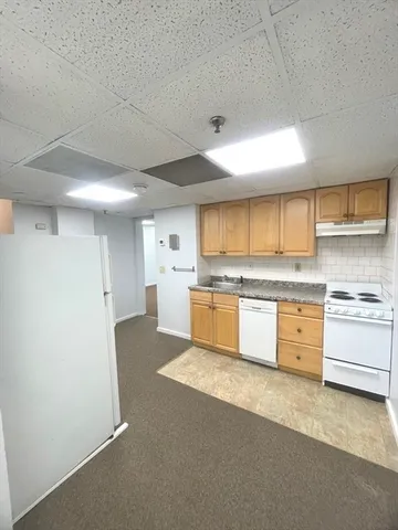 a large kitchen with kitchen island a sink stainless steel appliances and cabinets