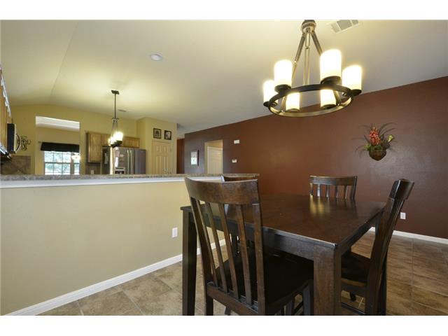 11612 Timber Heights Drive Austin, TX 78754 - Photo 20 of 28 These walls have been painted with neutral color. A classic chandelier illuminates the inviting dining space, seamlessly connected to a functional kitchen.