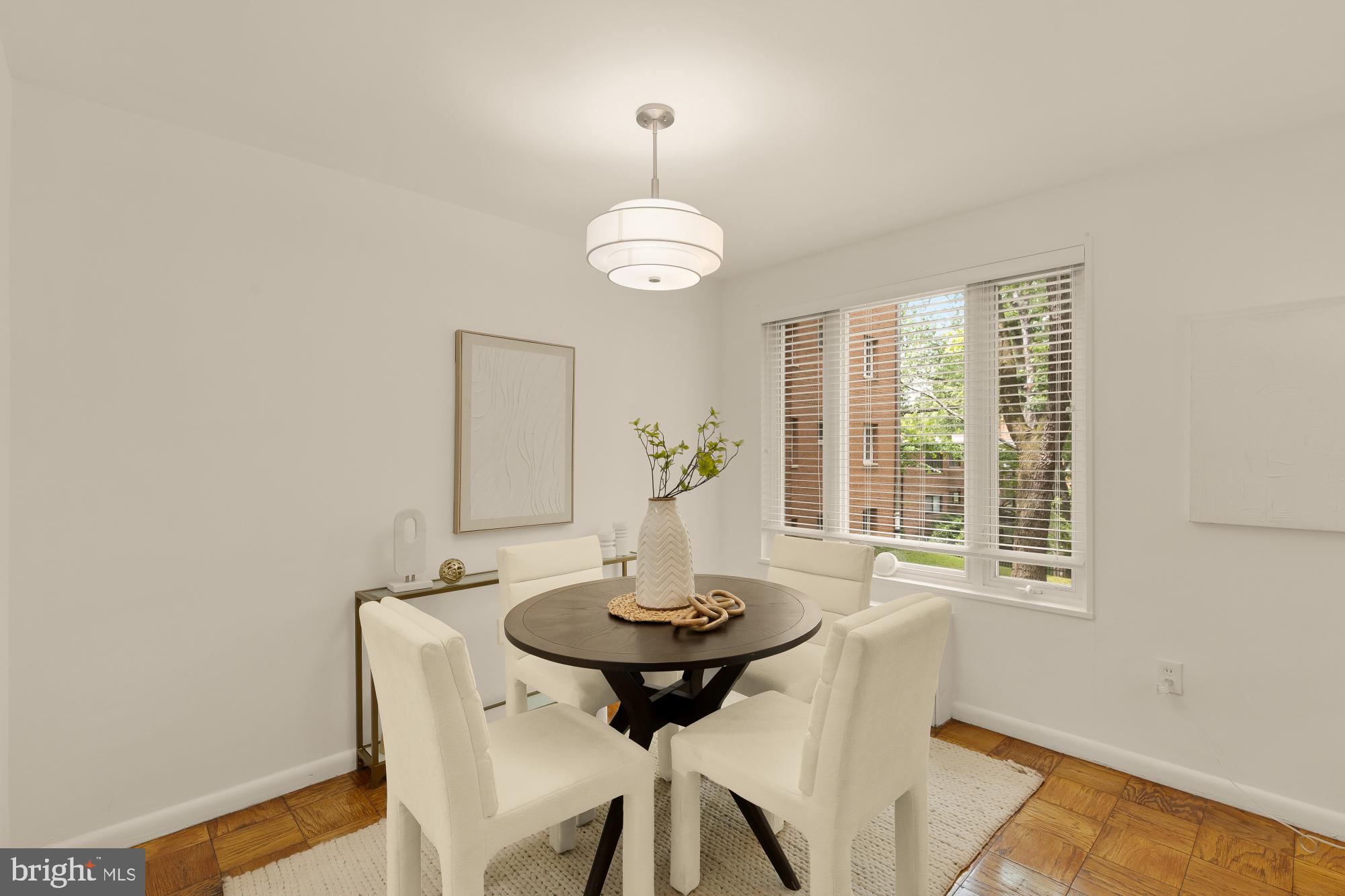 2400 41st Street Northwest, Unit 212 Washington, DC 20007 - Photo 7 of 24 a view of a dining room with a table and chairs