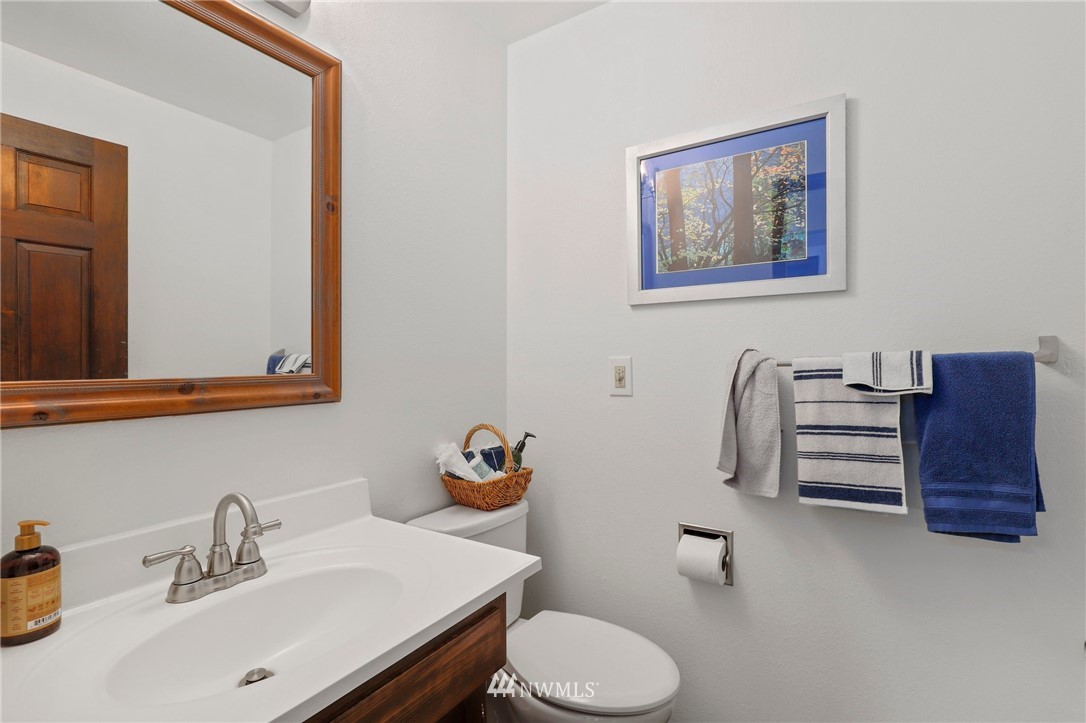 9302 Northeast 180th Street Bothell, WA 98011 - Photo 22 of 40 a bathroom with a toilet sink and mirror