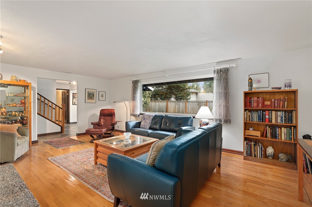 9302 Northeast 180th Street Bothell, WA 98011 - Photo 5 of 40 a living room with furniture and a bookshelf with wooden floor