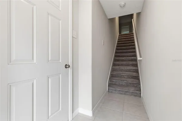 a view of a hallway with wooden floor and entryway