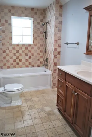 a bathroom with a sink a toilet and bathtub