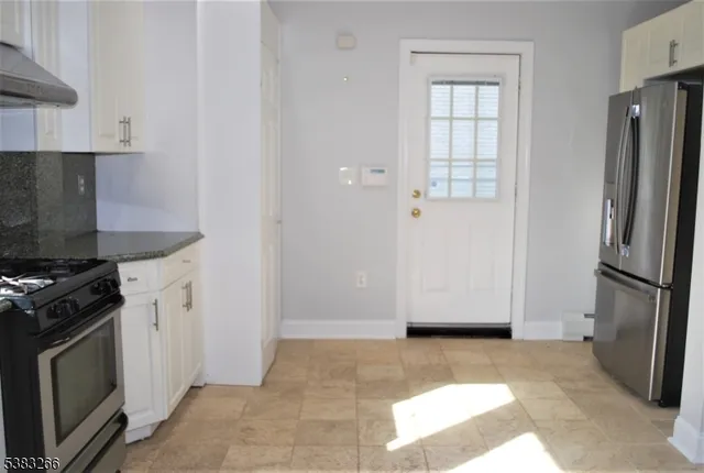 a stove top oven sitting inside of a kitchen