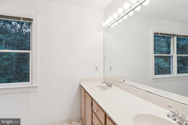 a bathroom with a sink and a window