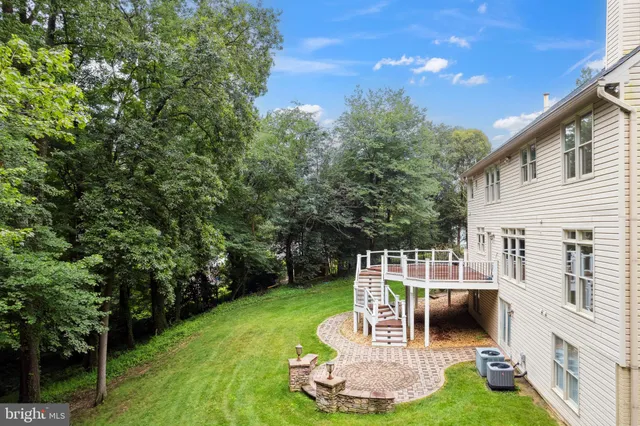 an aerial view of a house with a yard basket ball court and outdoor seating