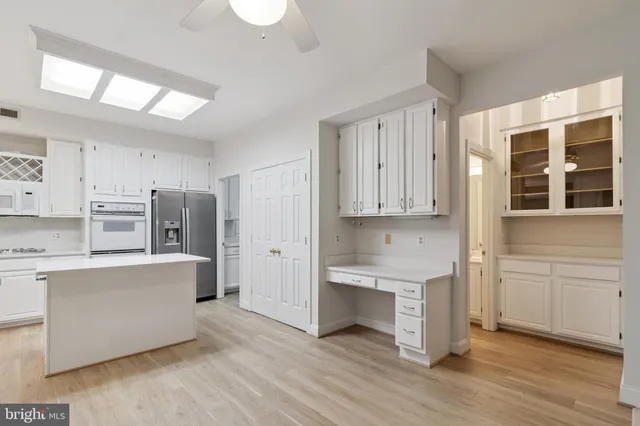 a kitchen with stainless steel appliances a refrigerator and a stove top oven