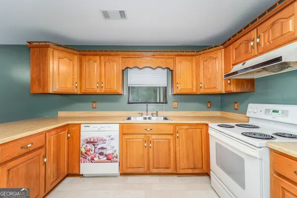 a kitchen with stainless steel appliances a stove a sink and a microwave