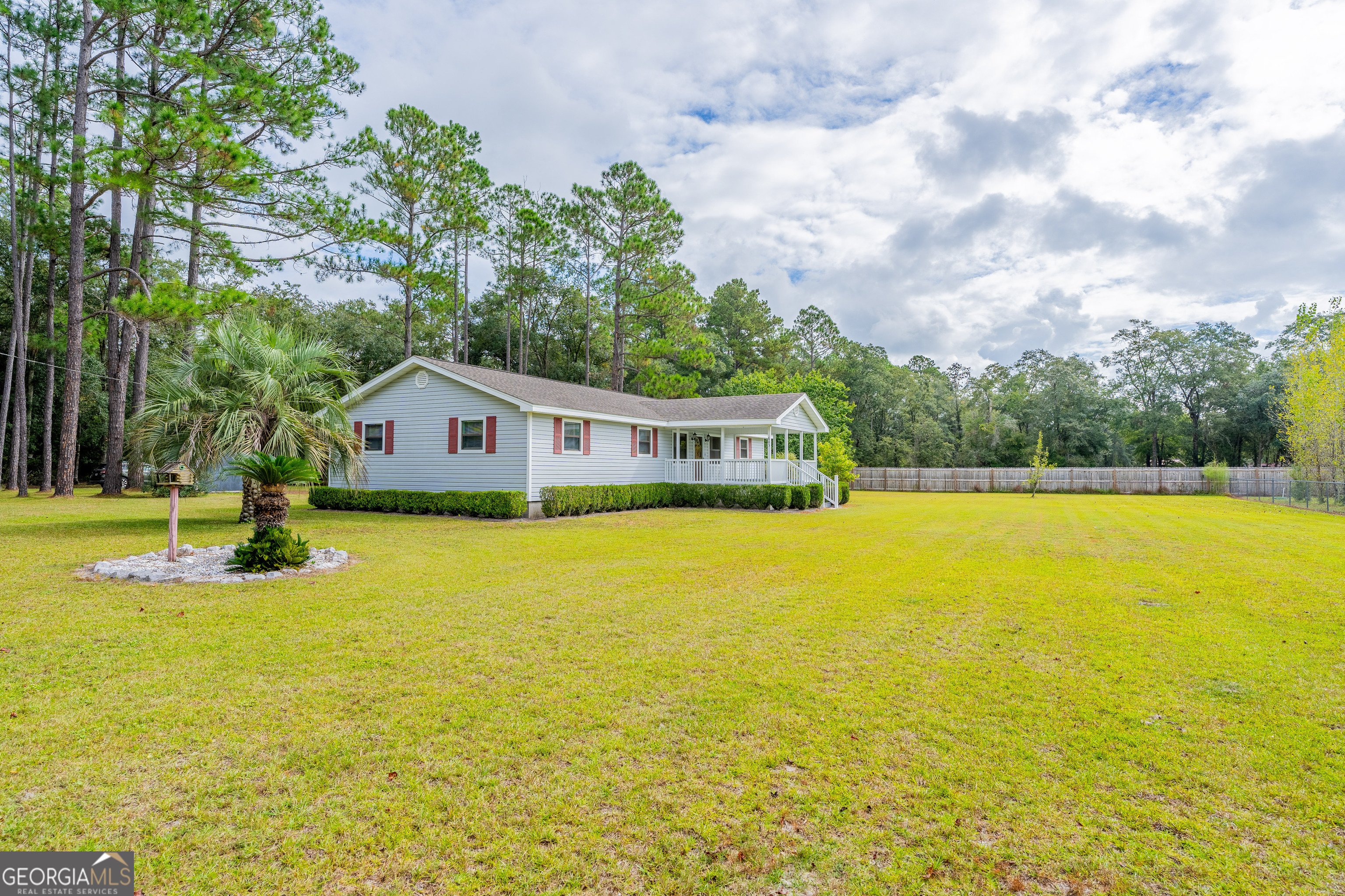 603 Cumberland Road Hortense, GA 31543 - Photo 2 of 26 a front view of a house with swimming pool