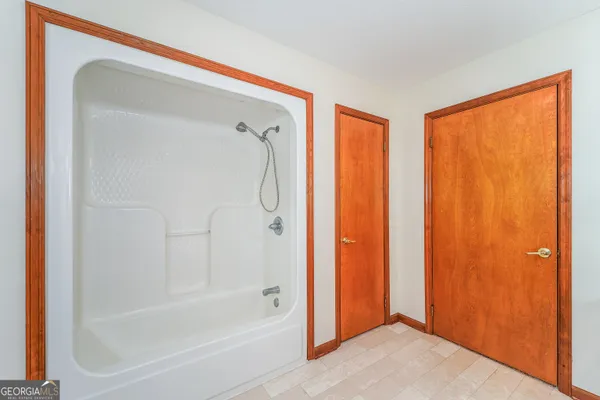 a bathroom with a bathtub and a shower