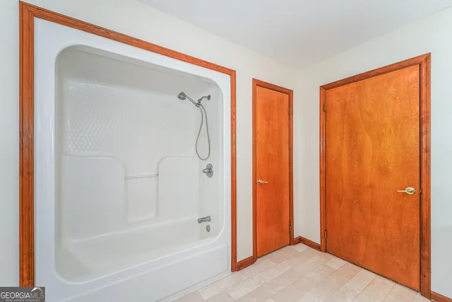 a bathroom with a bathtub and a shower