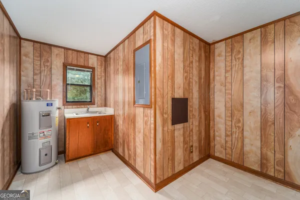 a view of a kitchen with kitchen island a refrigerator wooden floor and window