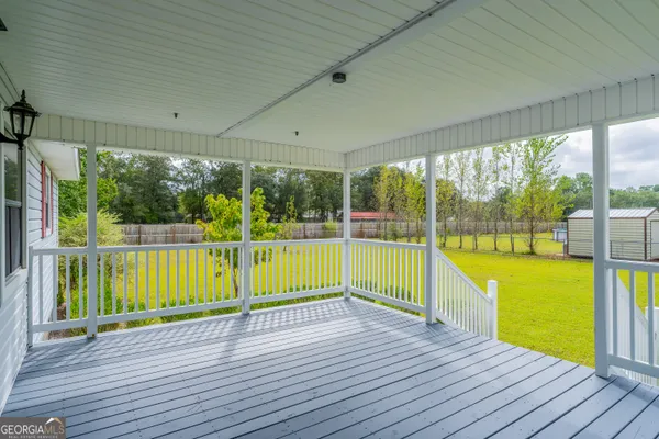 a view of a deck with a big yard