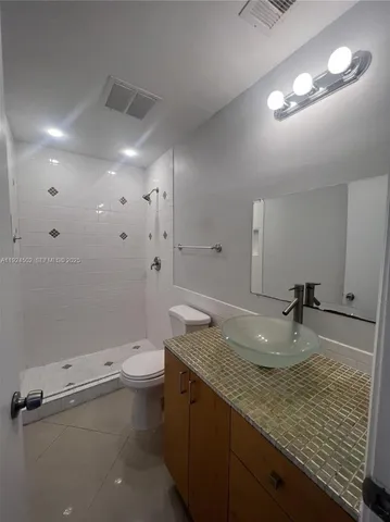 a kitchen with kitchen island granite countertop a sink cabinets and window