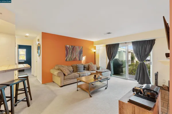 a living room with furniture a large window and a flat screen tv