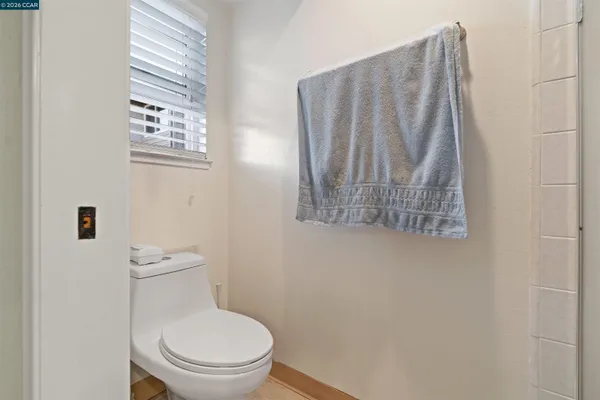 a white toilet sitting next to a shower