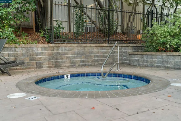 a front view of a house with plants and trees