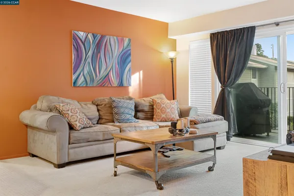 a living room with furniture a window and a table