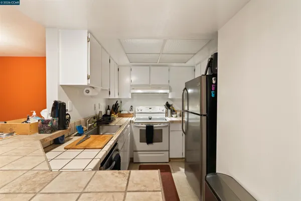 a kitchen with a sink cabinets and stainless steel appliances