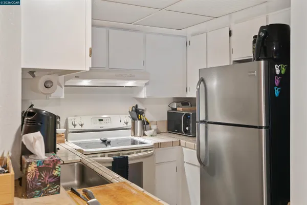 a kitchen with a refrigerator and a stove
