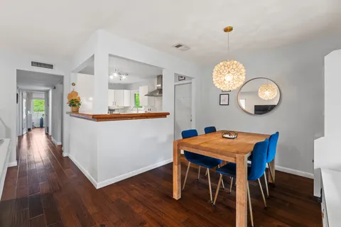 a view of a dining room with furniture and wooden floor