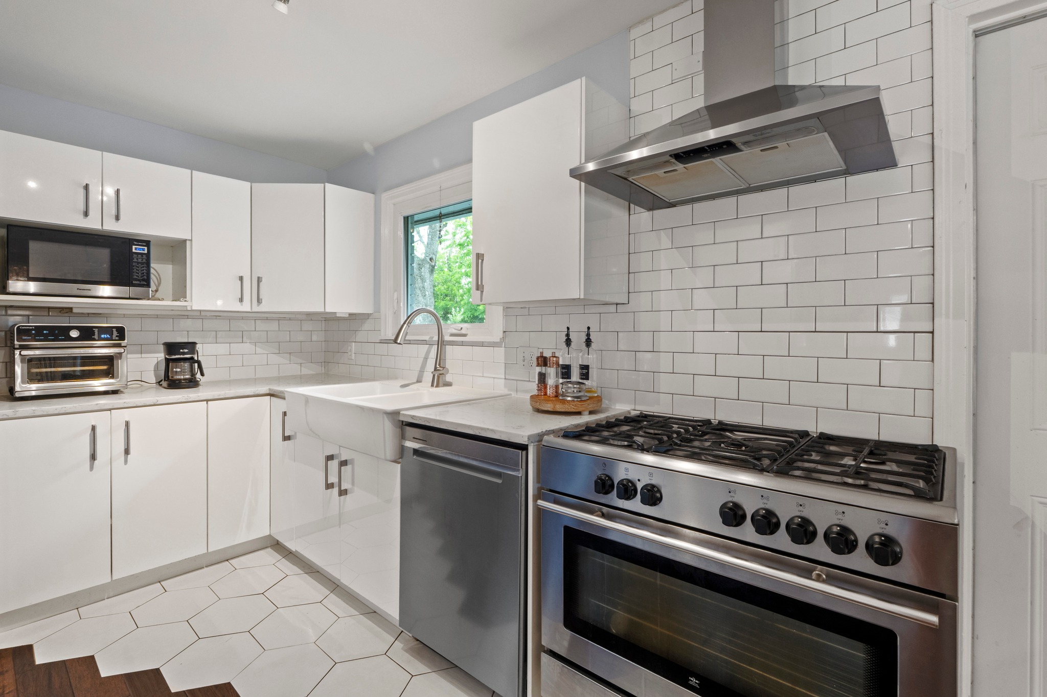 1301 Ridgemont Drive Austin, TX 78723 - Photo 18 of 32 a kitchen with a stove and a sink