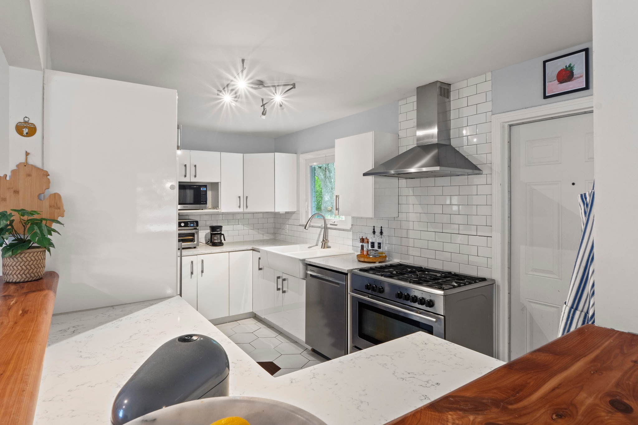1301 Ridgemont Drive Austin, TX 78723 - Photo 21 of 32 a kitchen with stainless steel appliances granite countertop a sink a stove and a refrigerator