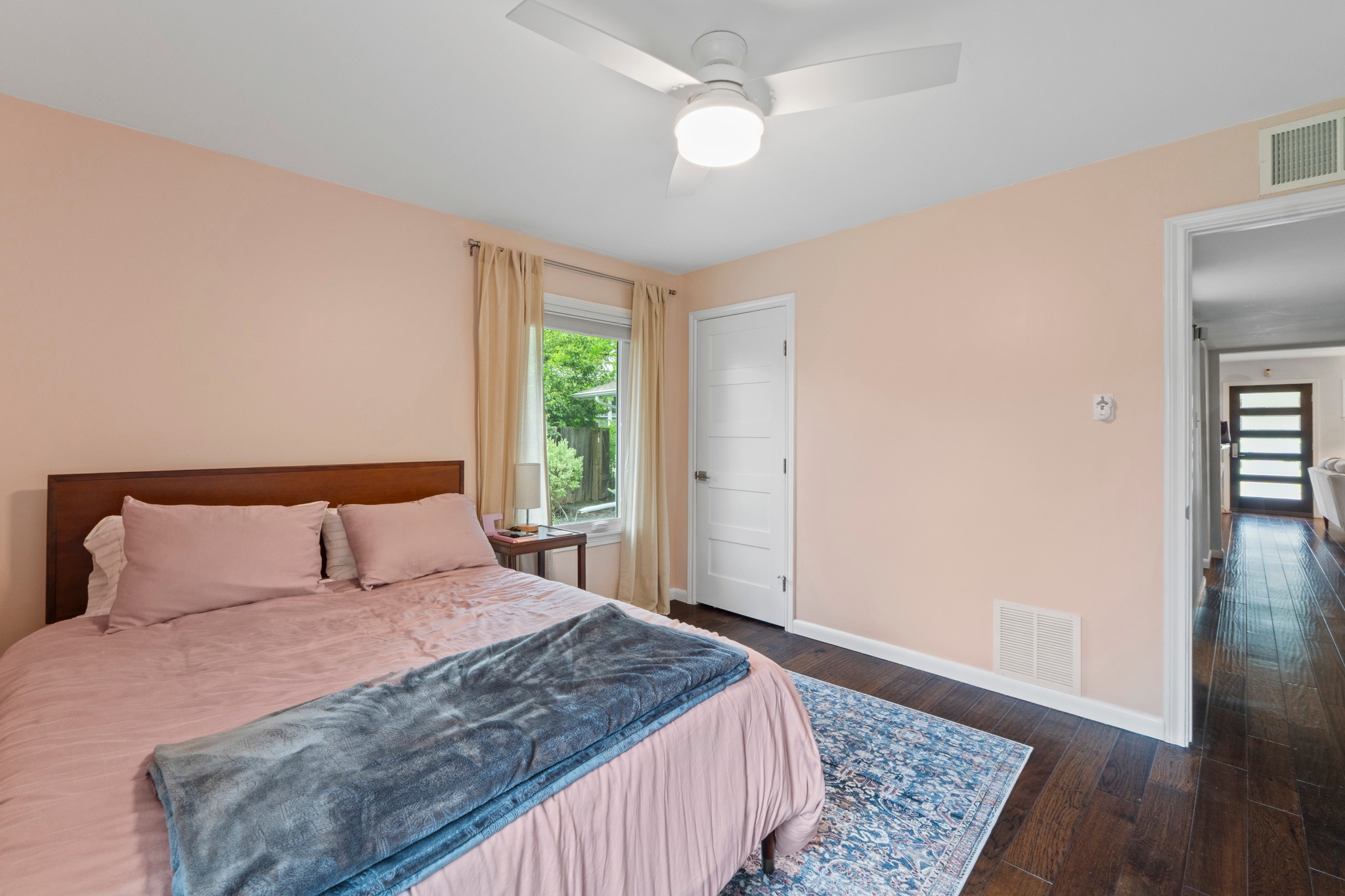 1301 Ridgemont Drive Austin, TX 78723 - Photo 23 of 32 a bedroom with a bed and wooden floor