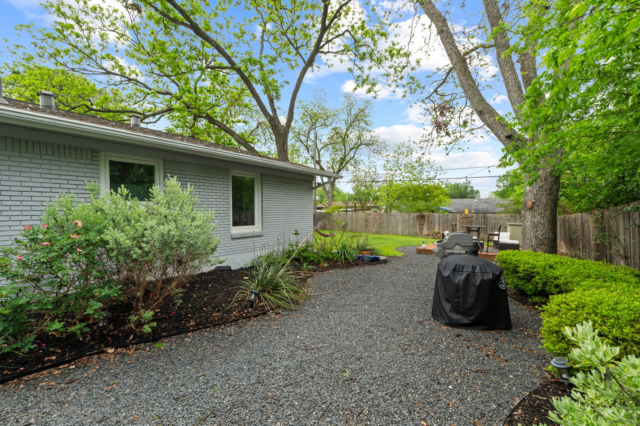 1301 Ridgemont Drive Austin, TX 78723 - Photo 28 of 32 a view of a backyard with plants and a large tree