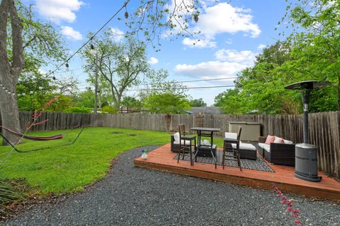 a view of a backyard with sitting area