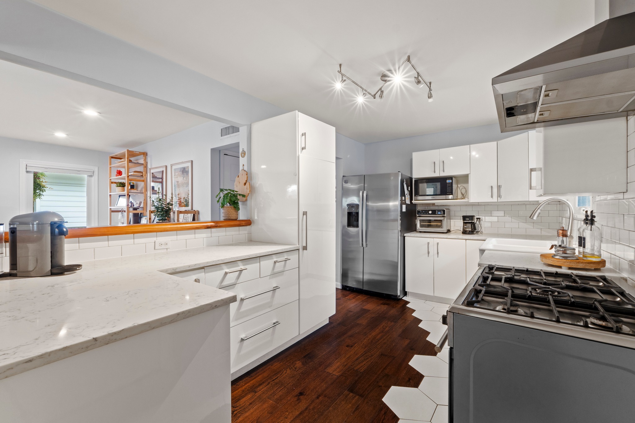 1301 Ridgemont Drive Austin, TX 78723 - Photo 4 of 32 a kitchen with stainless steel appliances granite countertop a refrigerator a sink dishwasher a stove and white cabinets with wooden floor