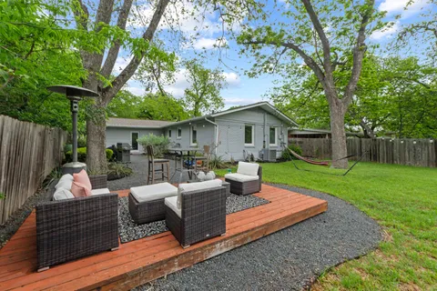 a view of a patio with couches chairs and a fire pit