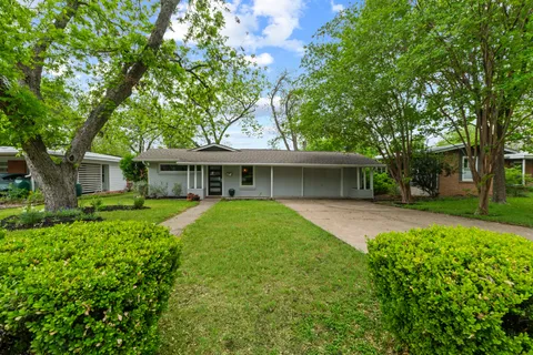 front view of a house with a garden