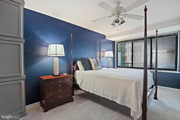 a bed room with a bed and a lamp