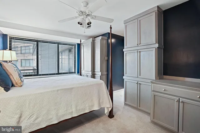 a bedroom with a bed dresser and a window