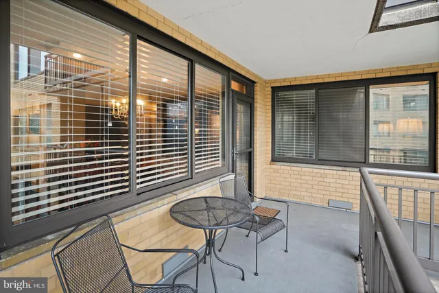 a balcony with table and chairs